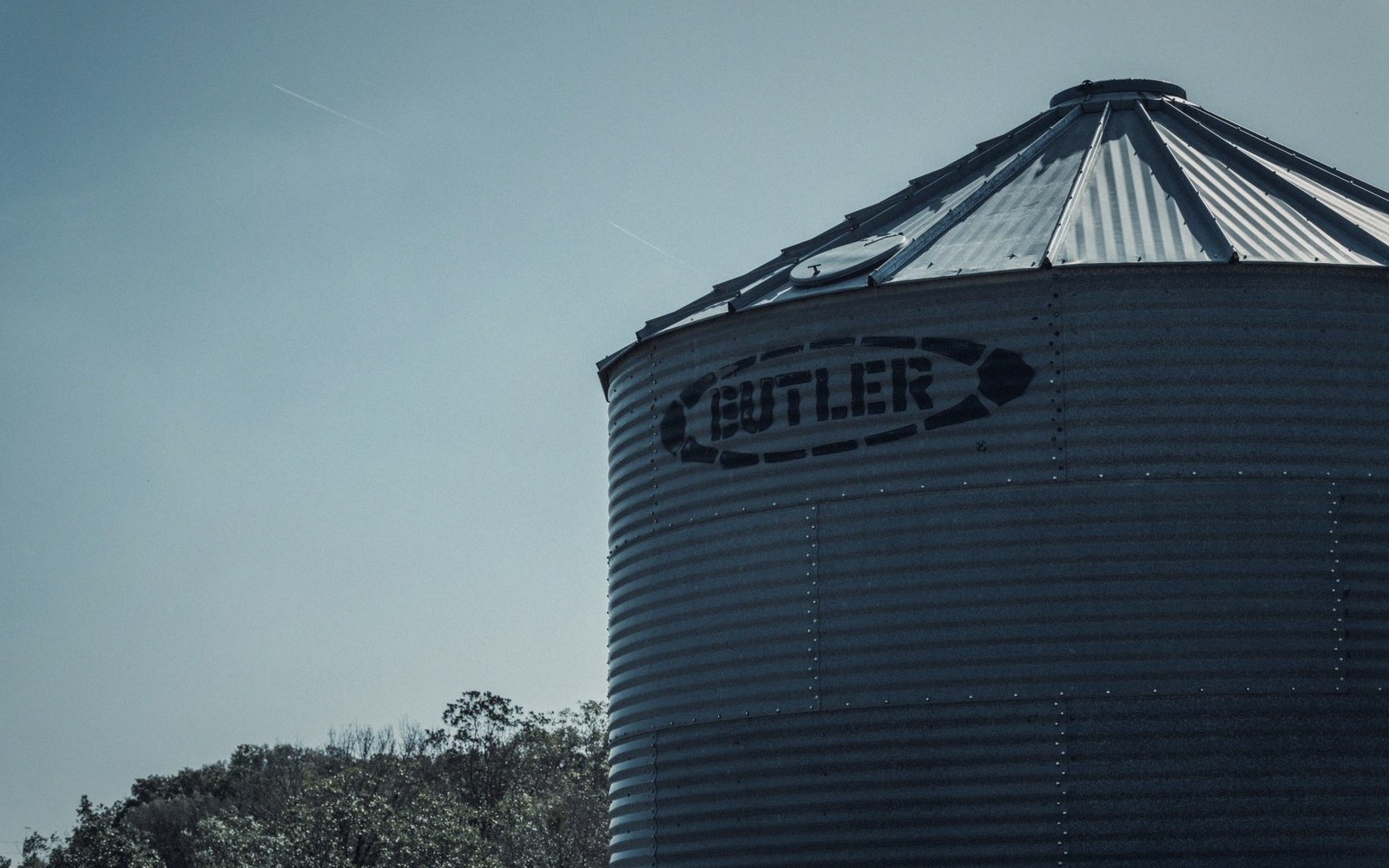 Steel grain bins with a drying fan at the base