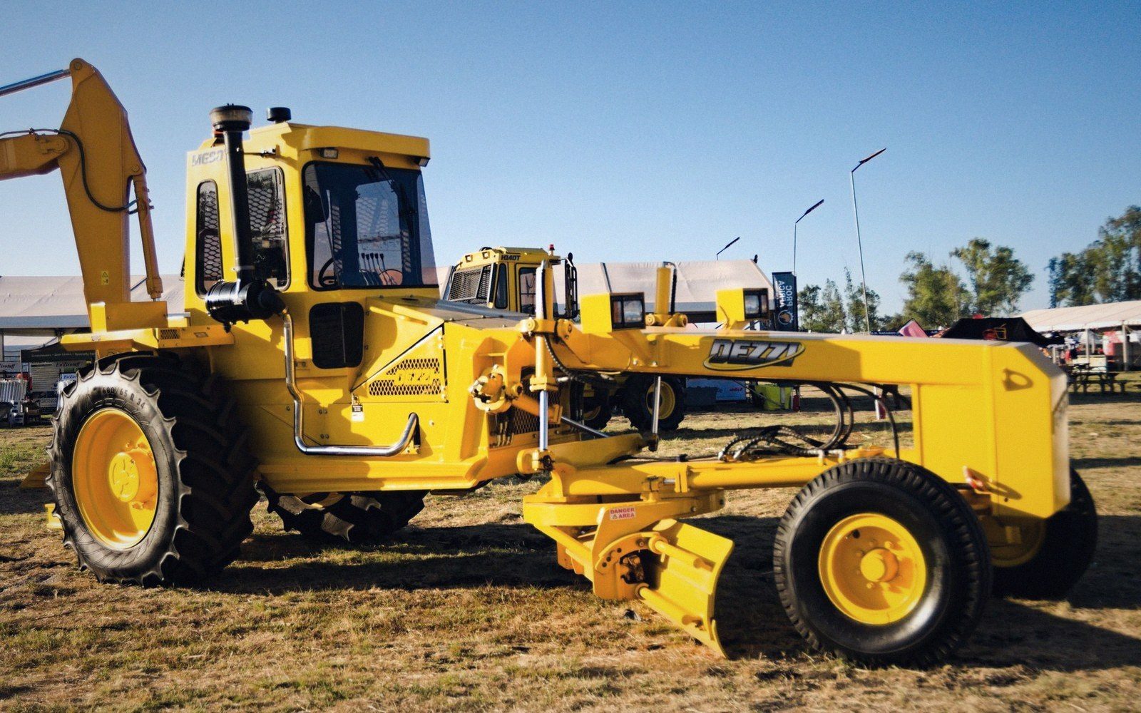 A laser-levelling scraper parked on dry cut ground